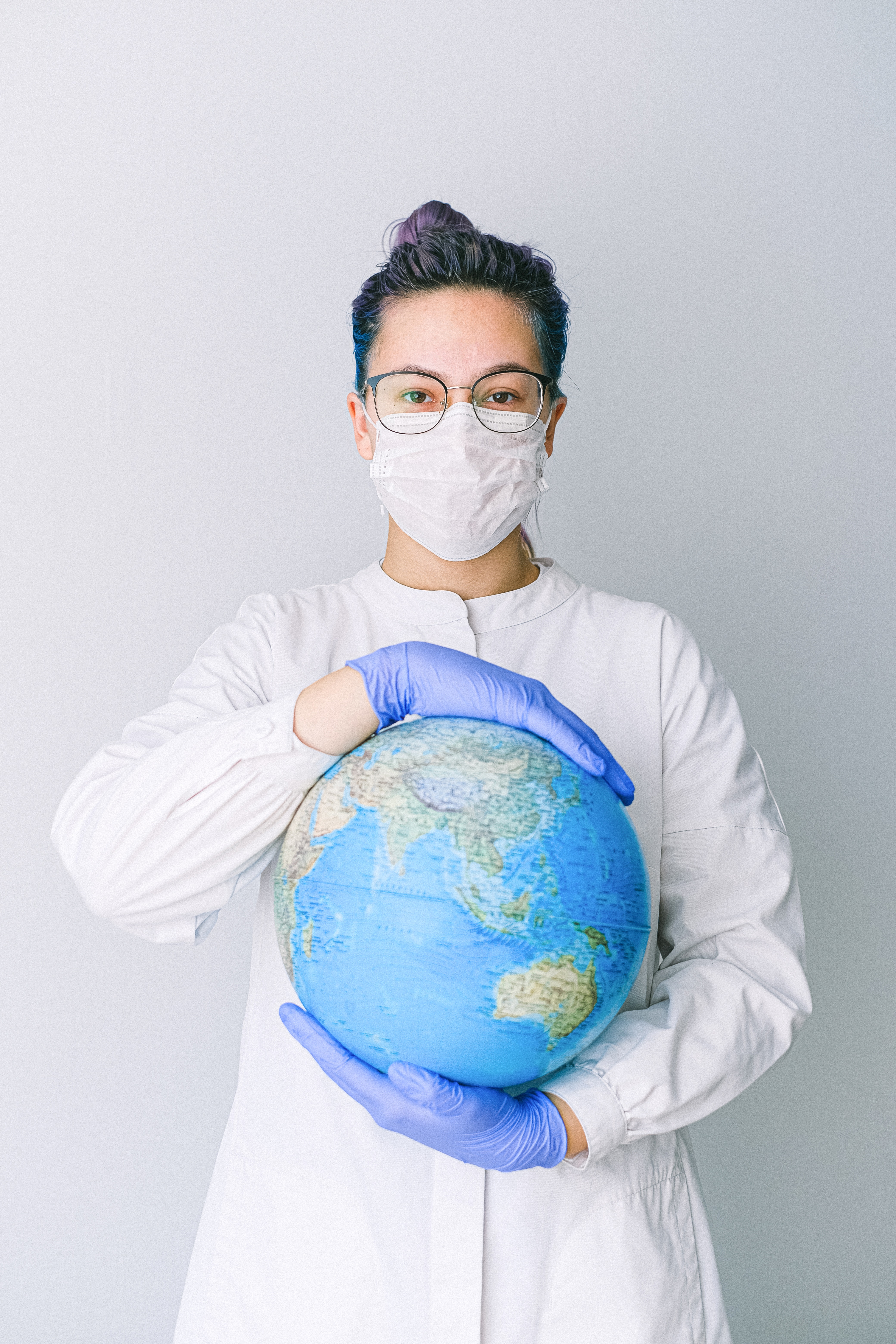 An image of a nurse holding world globe.